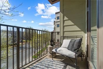 A balcony with a chair and a table at 1010 Dilworth Apartments, Charlotte, North Carolina